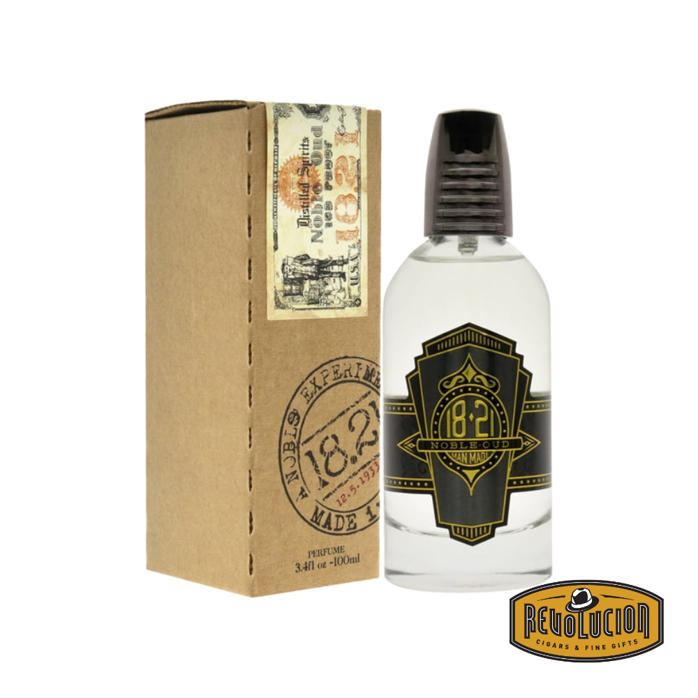 18.21 Man Made Spirits Noble Oud Parfum Spray bottle alongside its stylishly crafted box, exuding sophistication and luxury.