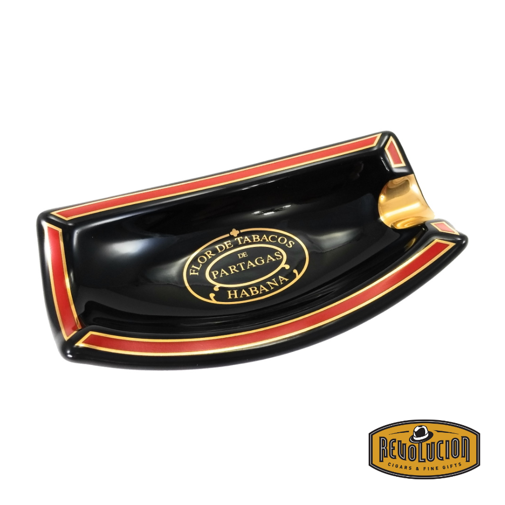 A side view of the Ashtray Habanos Partagas Serie 1 Cigar, featuring a sleek black ceramic body with red and gold trim, and the "Flor de Tabacos de Partagas Habana" emblem at the center.