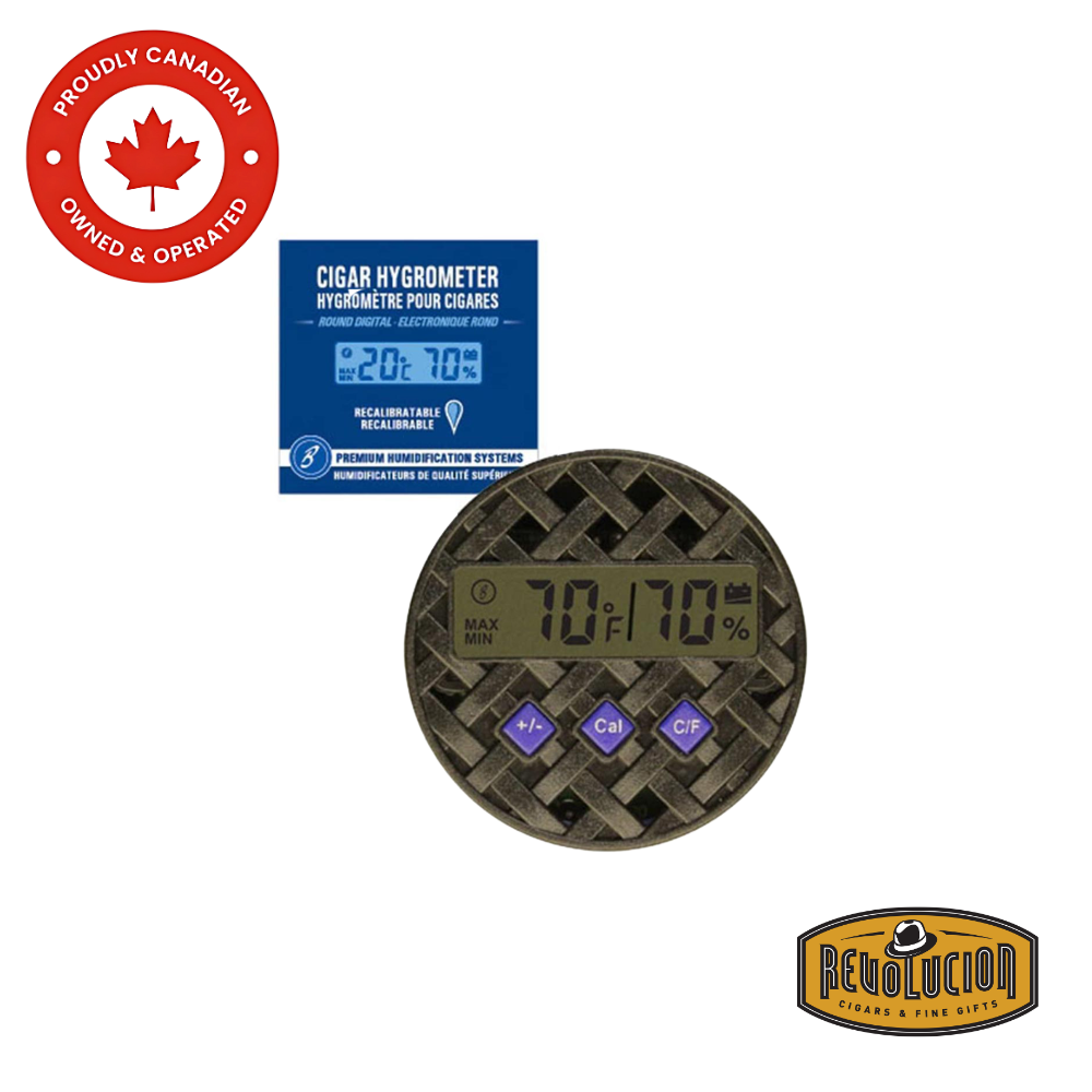 Brigham Enterprises Digital Round Hygrometer with its packaging in the background, featuring a sleek, compact design for precise humidity and temperature monitoring in humidors.