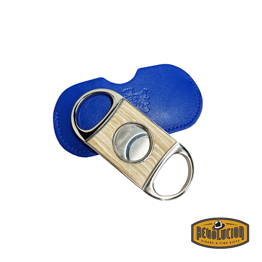 Brizard & Co. Double Guillotine II Cigar Cutter in bleached oak, displayed next to its royal blue leather case, showcasing a refined and premium aesthetic.
