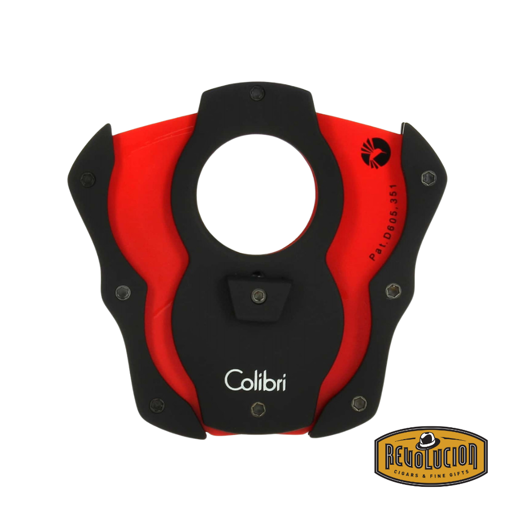 Open Colibri cigar cutter in black and red showing dual stainless steel blades, ergonomic grip, and brand logo, with Revolucion logo.