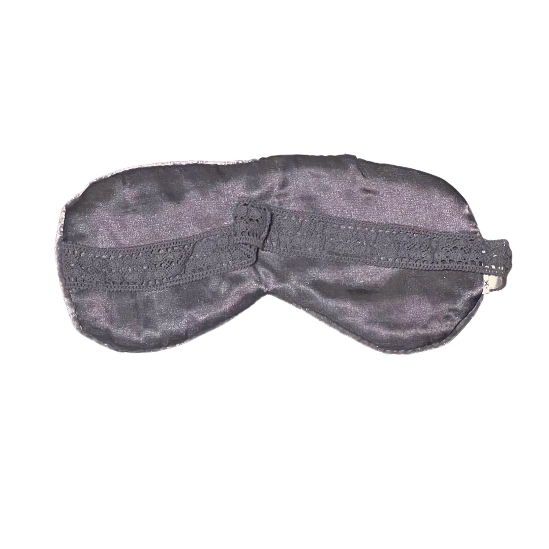 Black and grey sleep mask with a delicate lace-trimmed elastic band, designed for a comfortable and stylish fit.