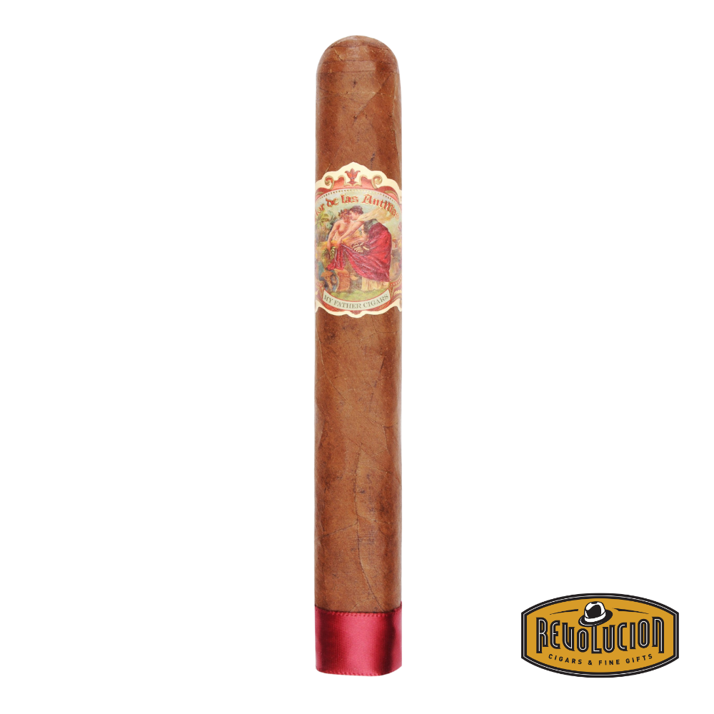 Flor de Las Antillas Toro cigar with sun-grown wrapper resting on a wooden humidor surface, band visible.