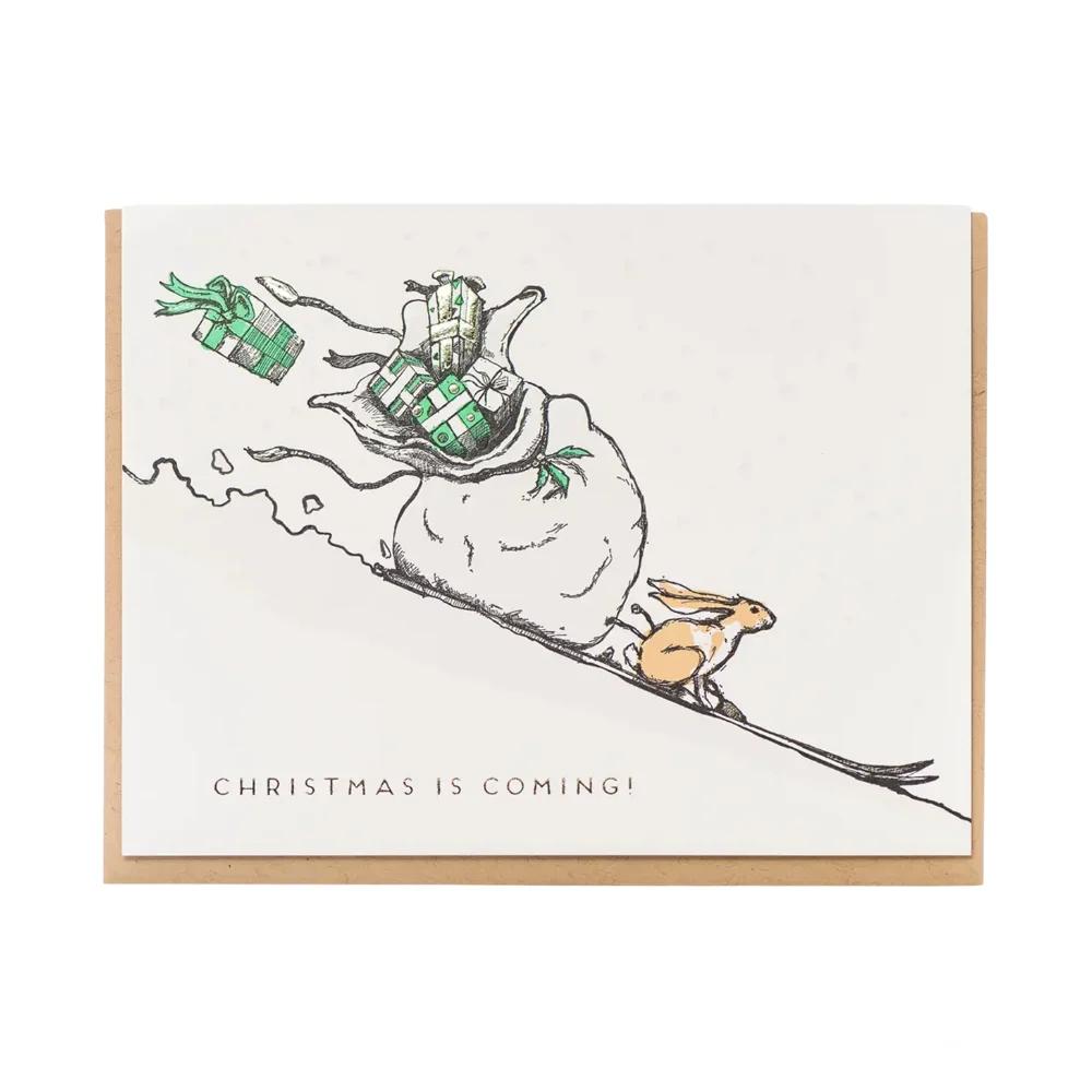 Front of the "Christmas is Coming Rabbit" greeting card, featuring a cute rabbit illustration in a festive winter setting.