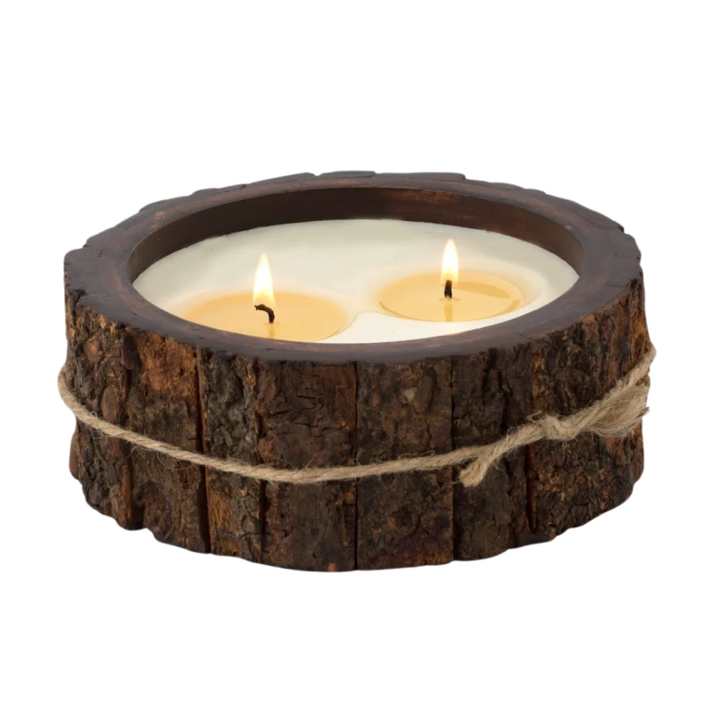 Himalayan Handmade Candles - Medium Tree Bark in Campfire, a lit candle with a rustic, bark-textured exterior.