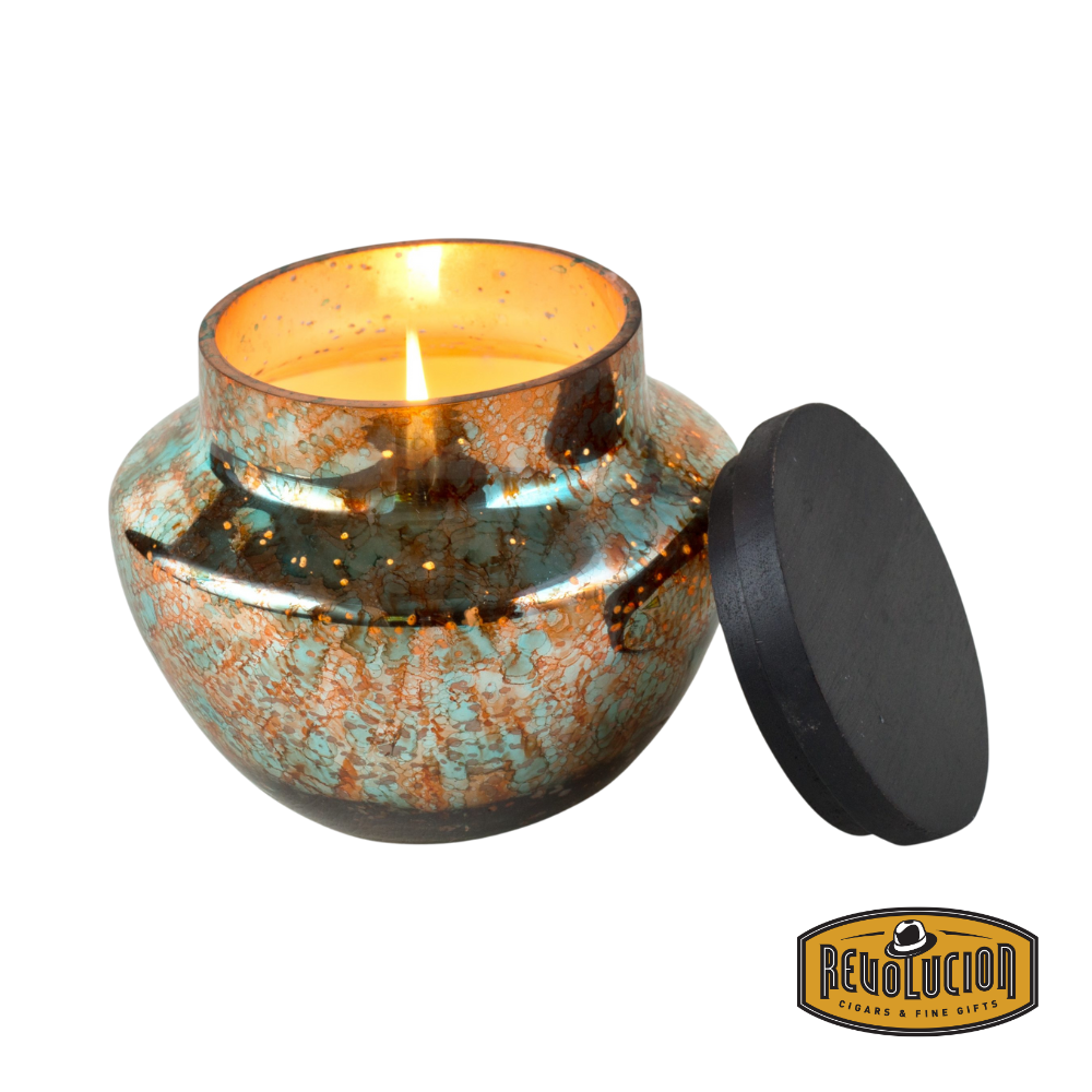 Himalayan Handmade Candles - Watercolor Glass in Turquoise & Copper, Sunlight in the Forest scent, 16 OZ candle lit and glowing.