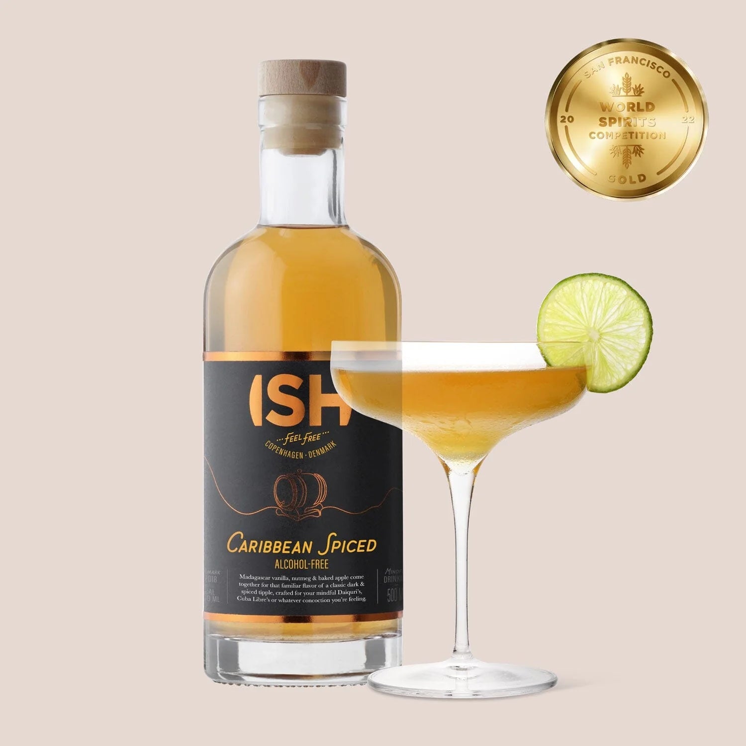A 500 ml bottle of ISH Caribbean Spiced Alcohol-Free Rum alongside a glass cup filled with a mocktail, showcasing its rich amber color and spice-infused aroma for a zero-proof alternative to traditional rum.
