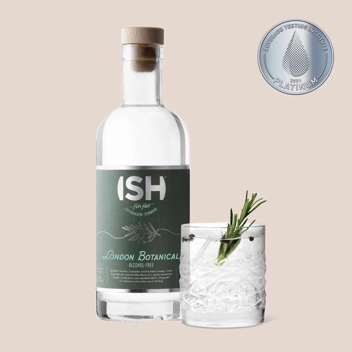 A 500 ml bottle of ISH London Botanical Alcohol-Free Gin next to a glass filled with a refreshing mocktail, illustrating the gin's crisp, herbal profile perfect for zero-proof cocktails.