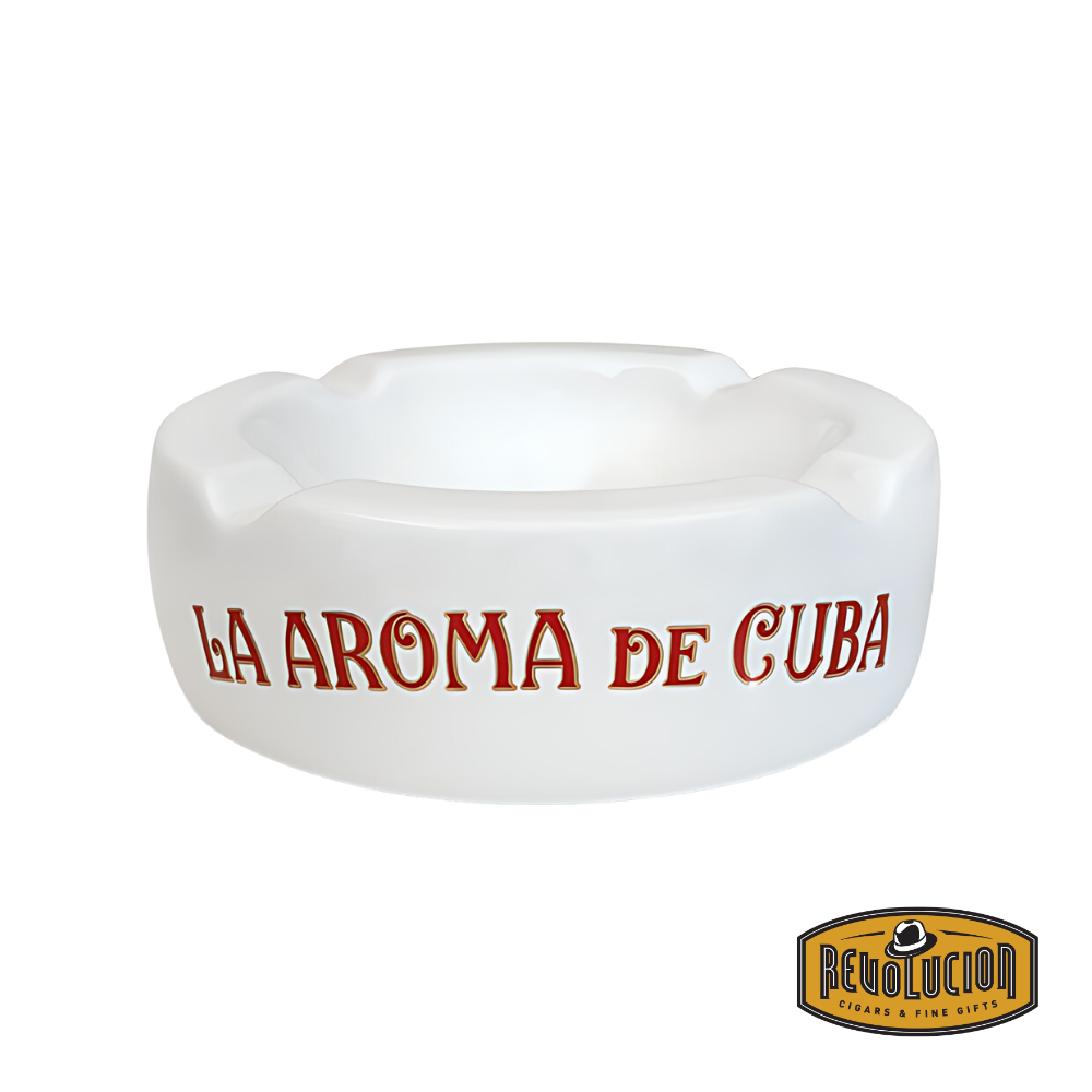 La Aroma de Cuba Ashtray in White, featuring a smooth ceramic finish with bold red branding, designed for holding cigars securely, displayed with the Revolucion Cigars & Fine Gifts logo.