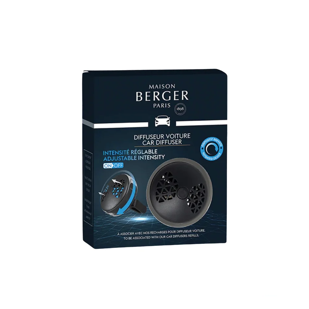 The photo shows the box of the Maison Berger Smart Car Diffuser, featuring an image of the diffuser on the front with its sleek and modern design in tones of black and gunmetal. The box is blue, includes the name of the product in white, along with its features such as the new patented system for adjusting the fragrance intensity.