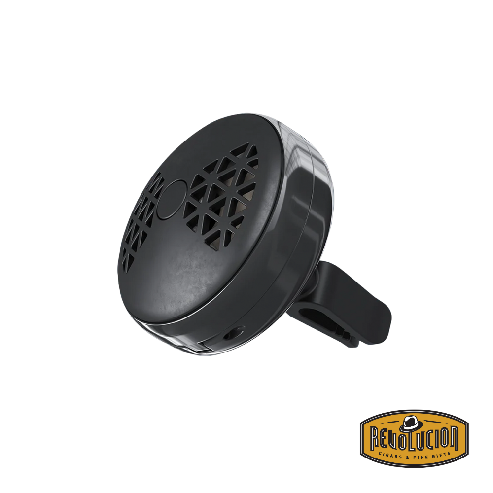 The photo shows the side of the Maison Berger Smart Car Diffuser, featuring a smooth and streamlined design in tones of black and gunmetal. The device has a small knob on the side that can be turned to adjust the fragrance intensity.