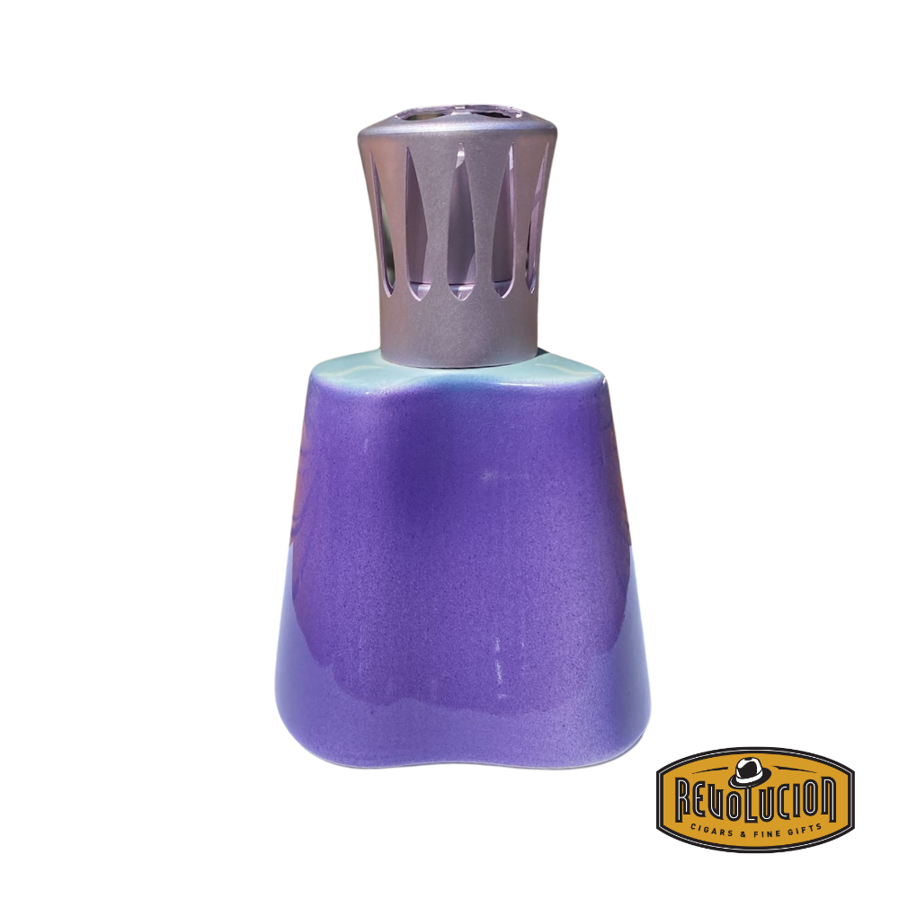 Lampe Berger Island Parme lamp featuring a soft, gradient finish of purple and turquoise with a metallic cutout diffuser cap, displayed on a white background with Revolucion logo.