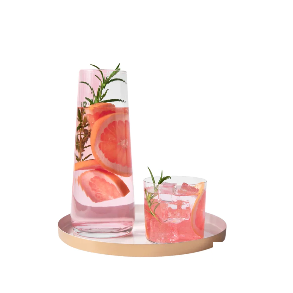 Avant-Garde Lumi Water Set in use, displaying the glass carafe filled with grapefruit and rosemary-infused water, accompanied by a matching textured glass on a tray.