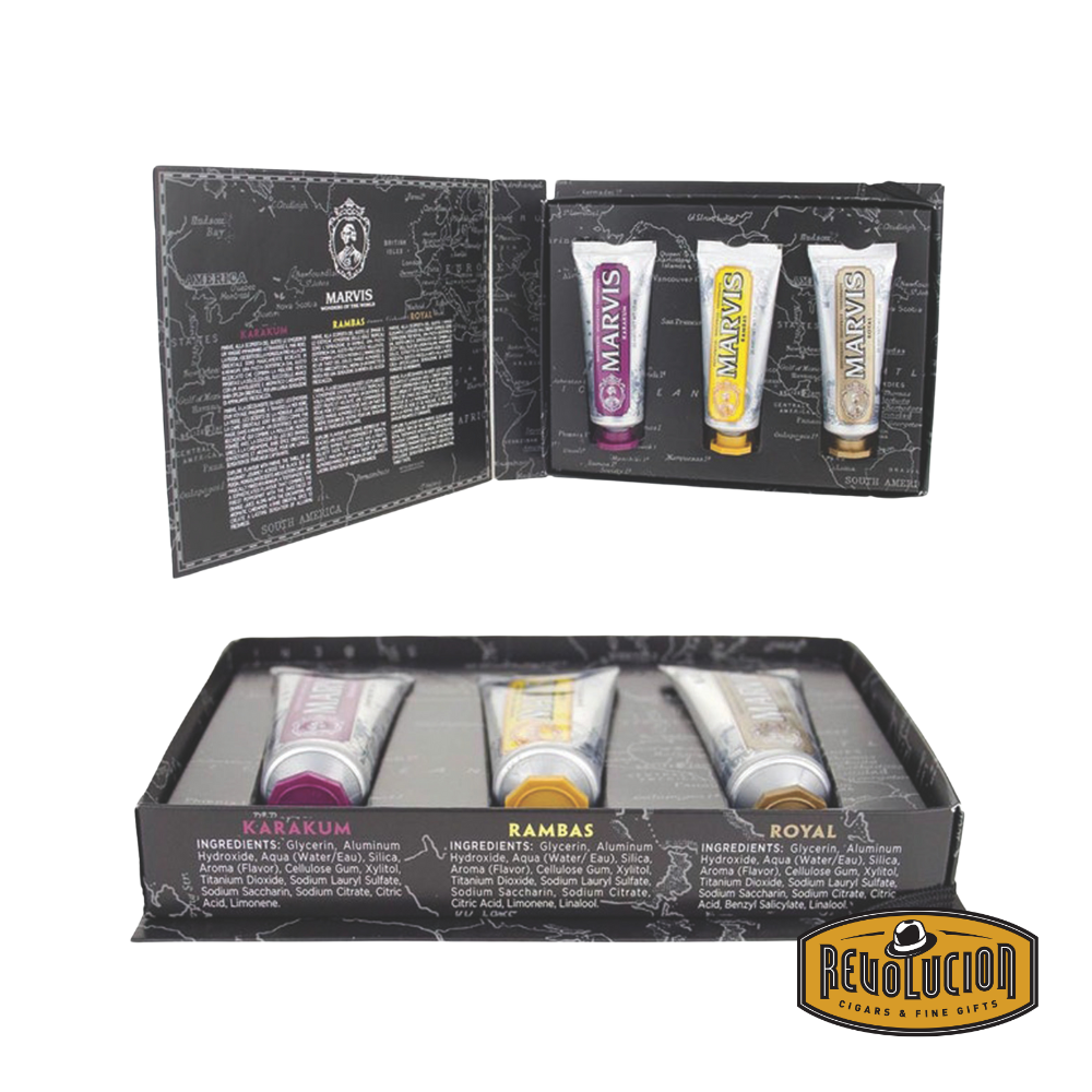 Opened Marvis Wonders of the World travel set displaying the inside cover with detailed descriptions of the three unique toothpaste flavors.