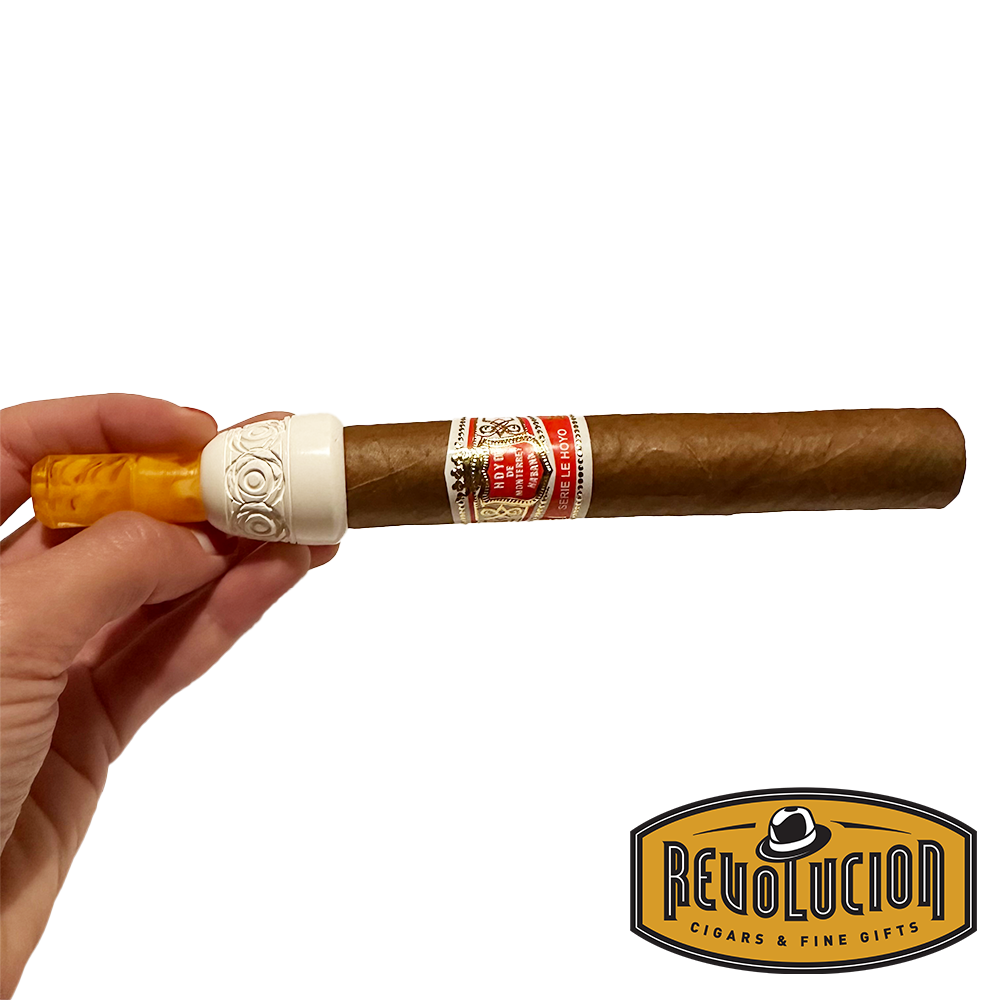 Meerschaum cigar holder securely holding a premium cigar, showcasing its ergonomic and stylish design.