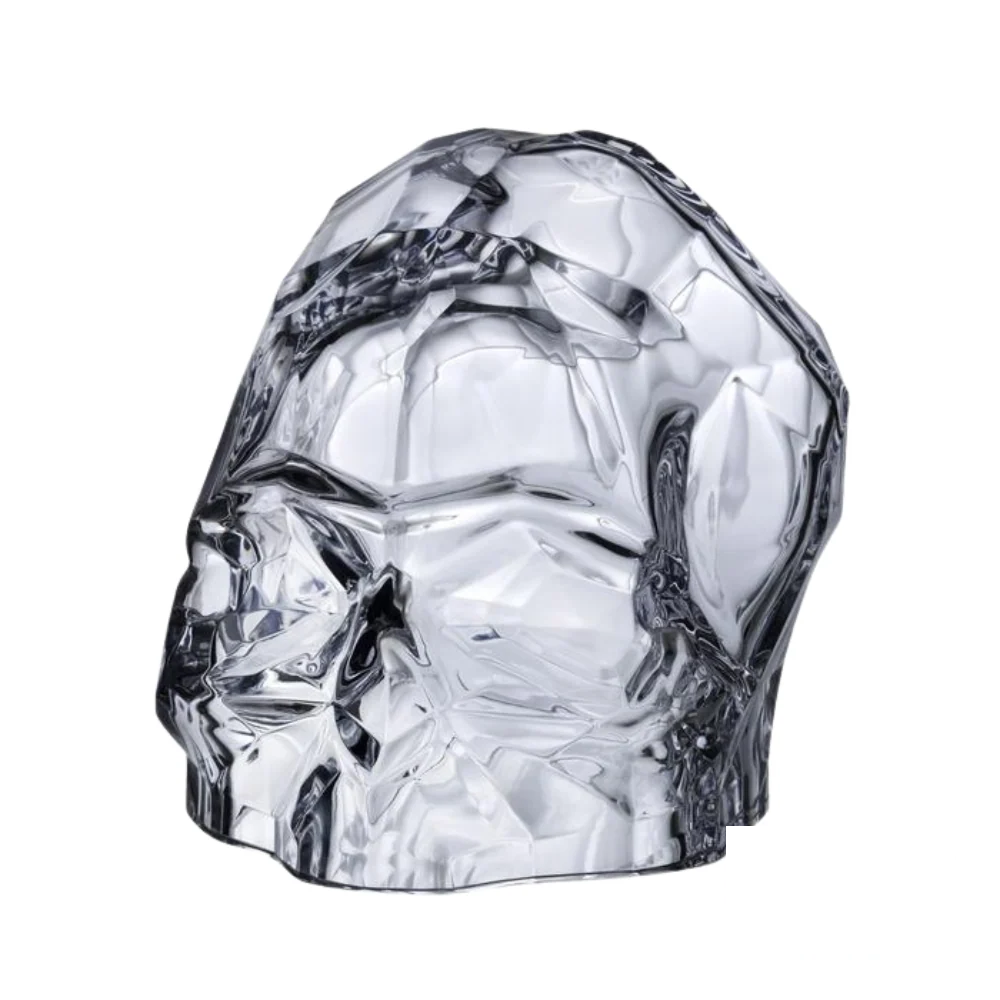 Nude Memento Mori Faceted Skull in Clear Glass, showcasing intricate geometric faceting and smooth, transparent design.