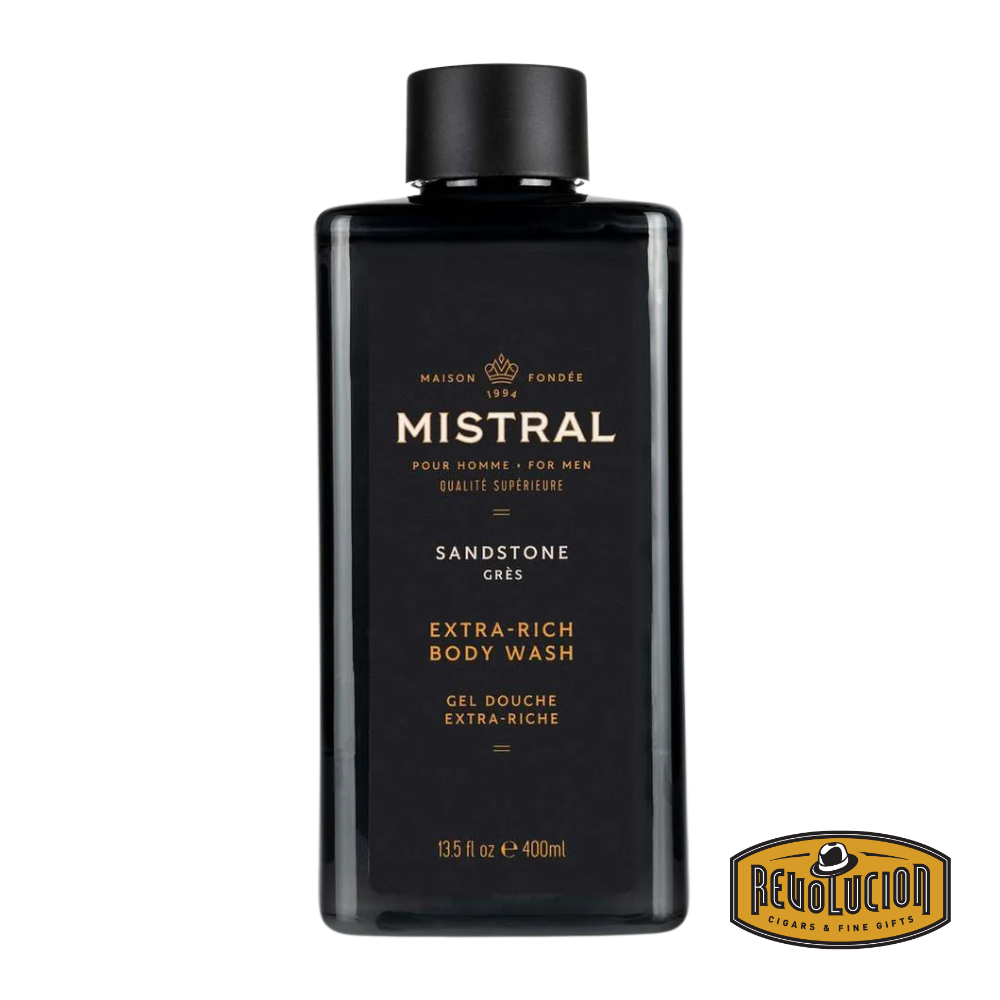 Mistral Men's Extra Rich Body & Hair Wash in Sandstone scent, displayed in an earth-toned bottle that evokes rugged natural textures and desert-inspired warmth.