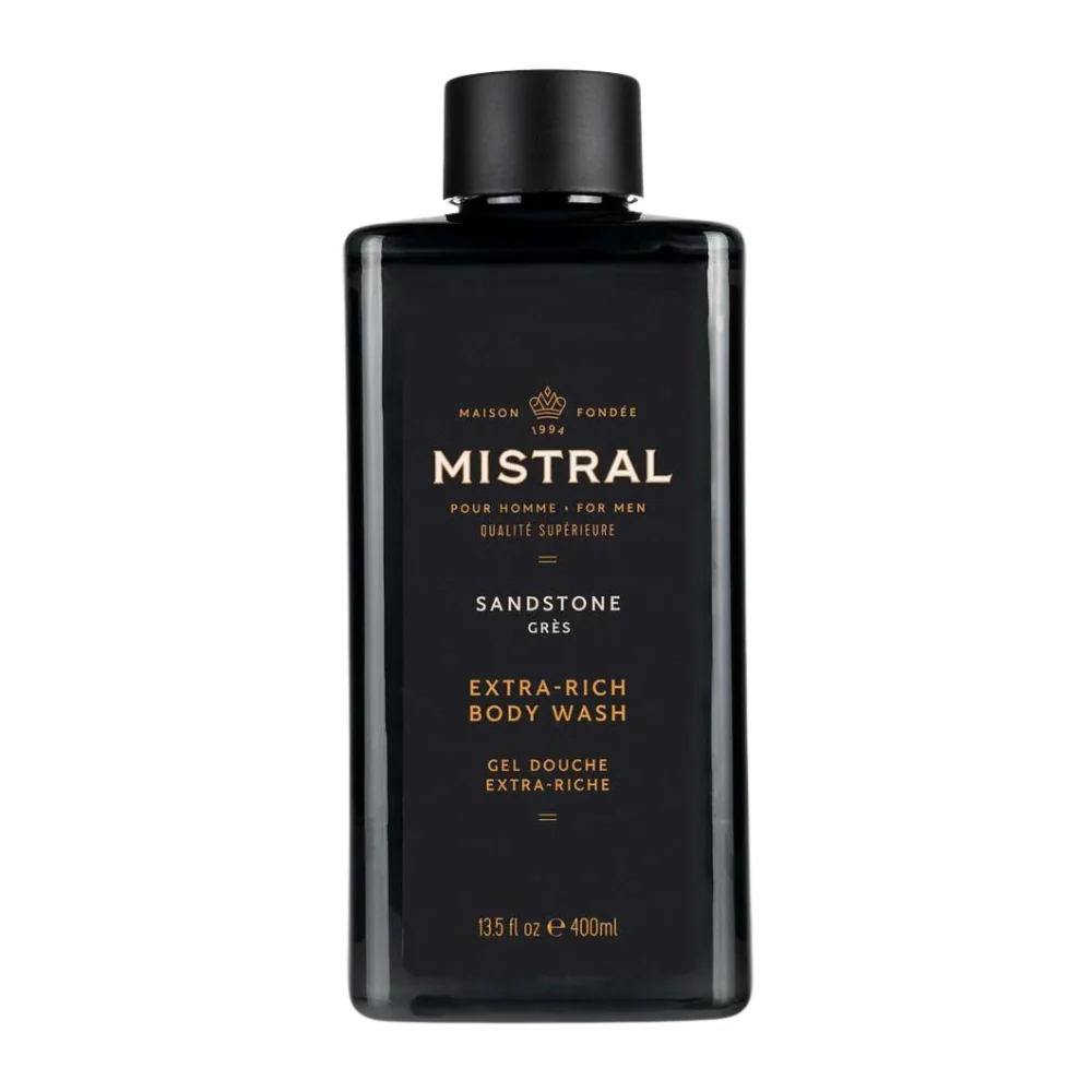 Mistral Men's Extra Rich Body & Hair Wash in Sandstone scent, displayed in an earth-toned bottle that evokes rugged natural textures and desert-inspired warmth.