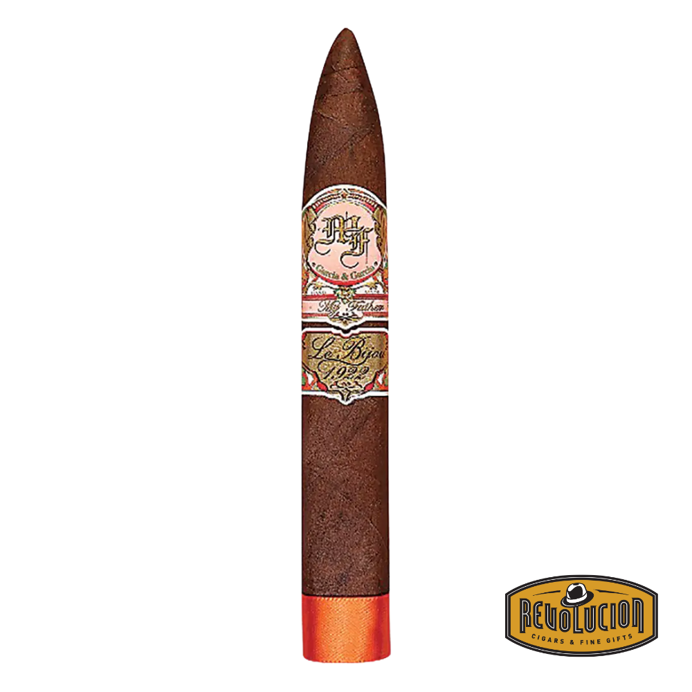 My Father Le Bijou 1922 Torpedo cigar with a dark oily wrapper, placed elegantly beside a cutter and glass of bourbon.