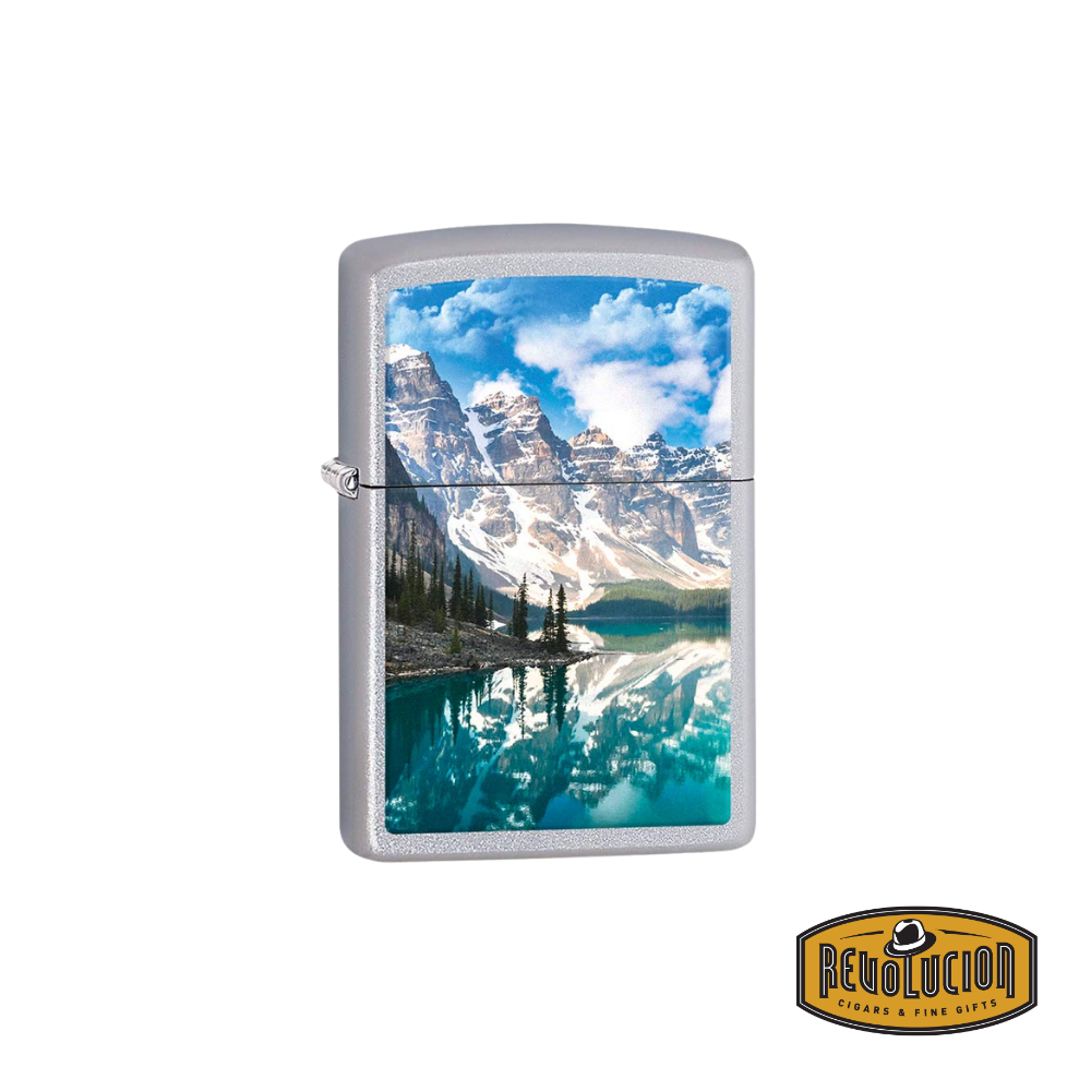 A Zippo lighter featuring a stunning full-color print of Moraine Lake in the Canadian Rockies, showcasing its turquoise waters, towering mountains, and a vivid blue sky with fluffy clouds. The reflective surface of the lake enhances the breathtaking scenery.