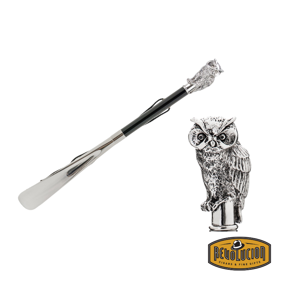 Pasotti Shoehorn with an intricately designed owl head handle in polished silver-tone, complemented by a sleek black shaft and a convenient leather strap.