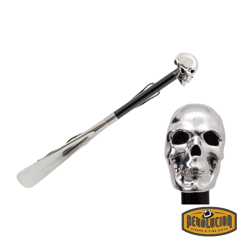 Pasotti Shoehorn featuring a striking black skull handle, a sleek black shaft, and a refined leather strap for easy handling.