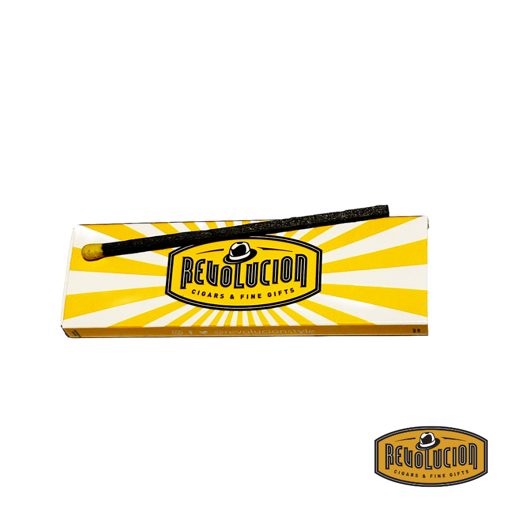 A box of Revolucion Premium Wooden Matches with one match placed outside, showcasing its elegant design.