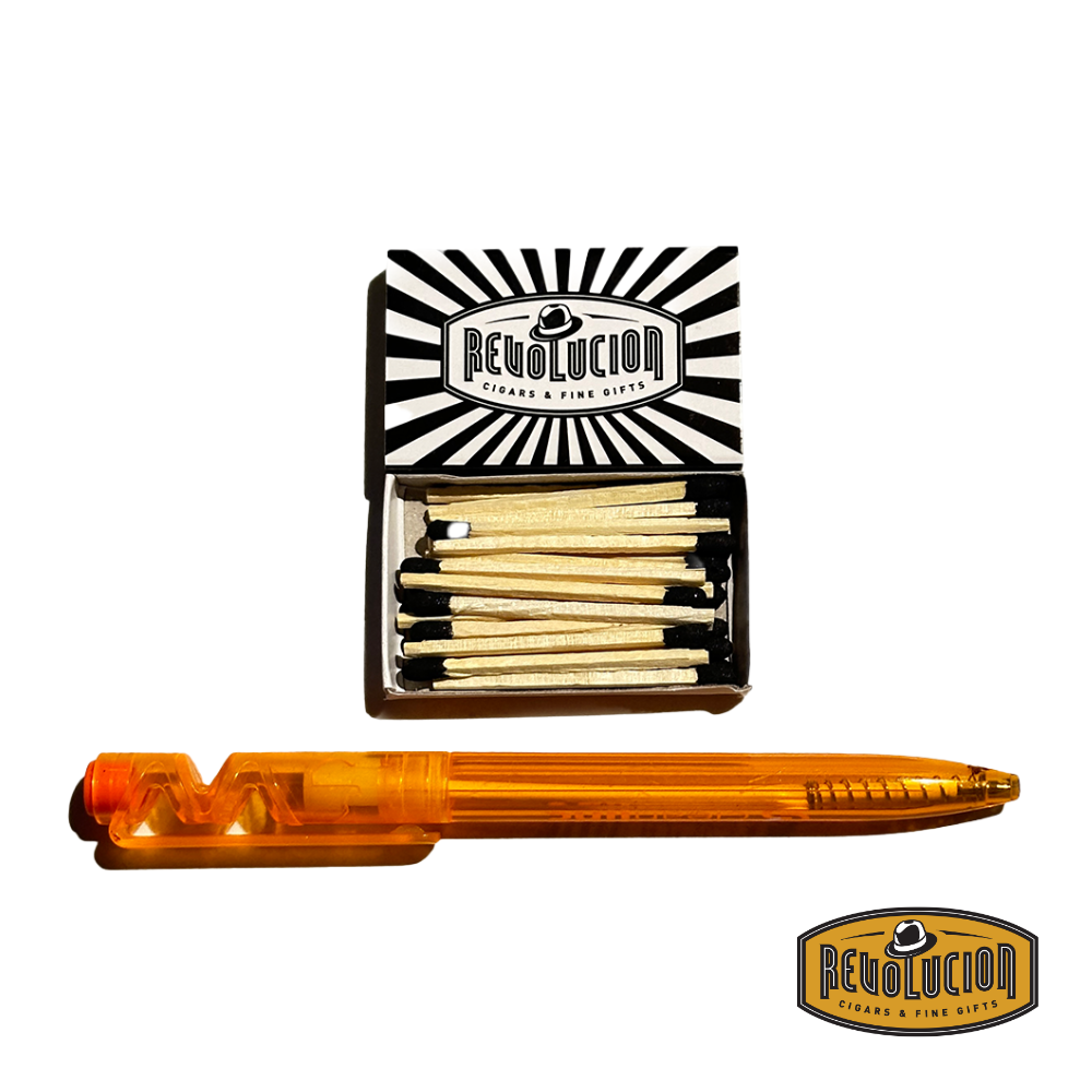 An opened box of 4" Revolucion matches, showing neatly arranged wooden matches beside a pen for scale.