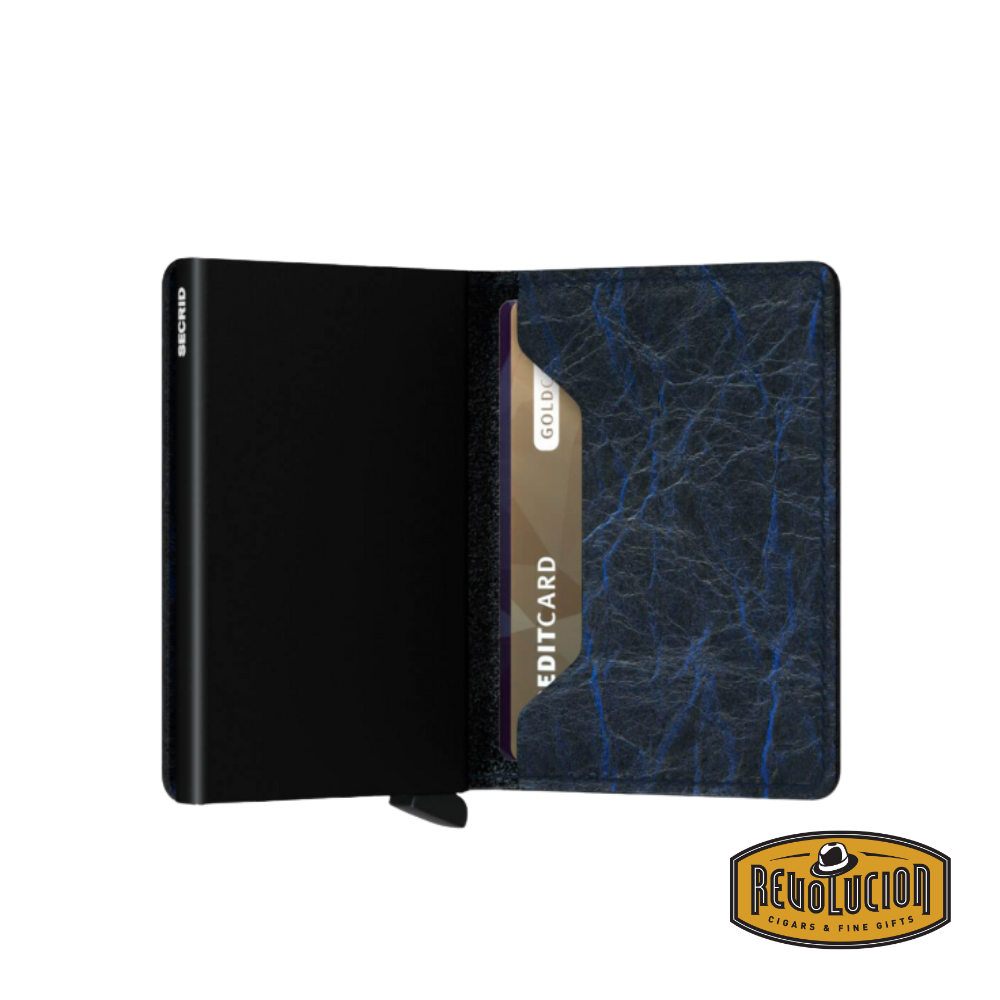 The Secrid Slimwallet in vintage blue, partially open, revealing card storage with an aluminum cardholder mechanism.