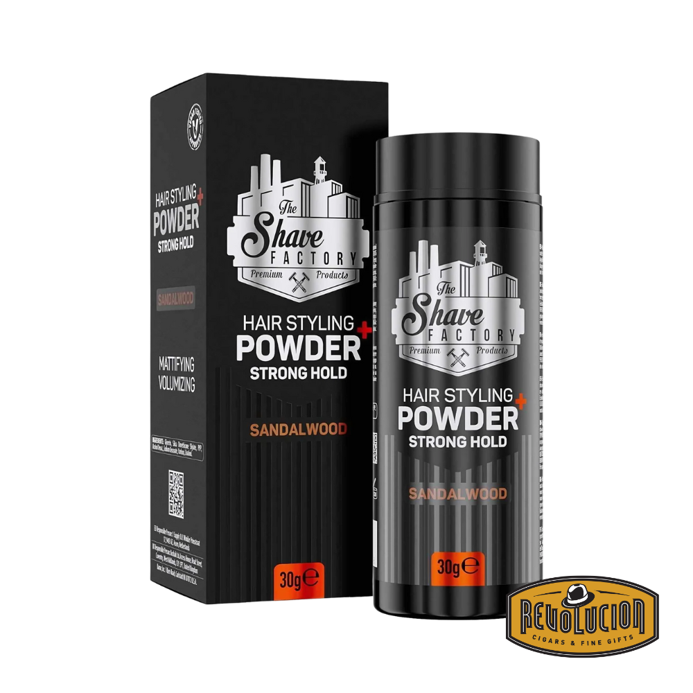 The Shave Factory Hair Styling Powder Strong Hold in Sandalwood scent, shown with its matte black container and matching box featuring silver industrial-style branding and orange highlights.