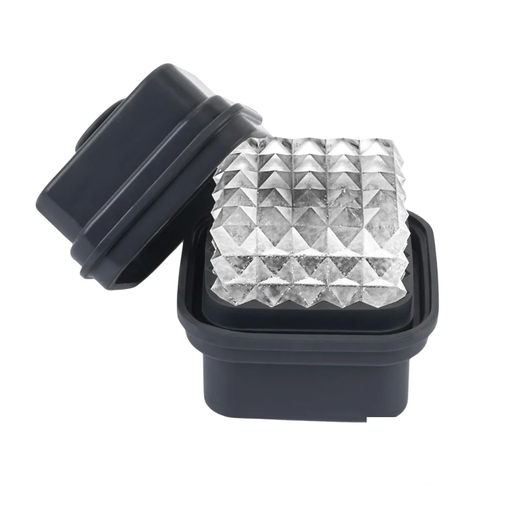 W&P Prism Ice Cube Tray in charcoal with a geometric prism-shaped ice cube resting inside.