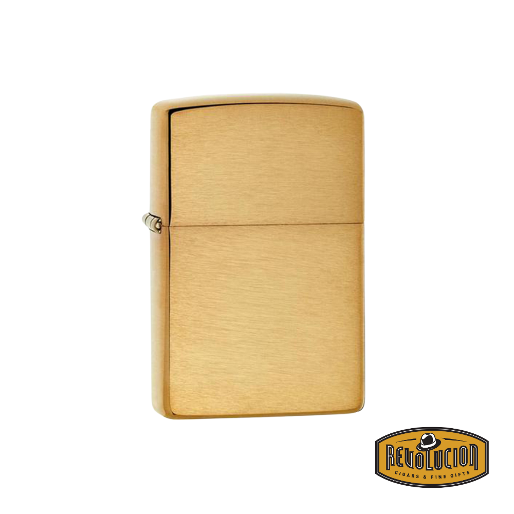 A Zippo Pure Armor Brushed Brass Lighter, showcasing its elegant brushed brass finish and sturdy Armor case, with the iconic Revolucion logo in the corner.