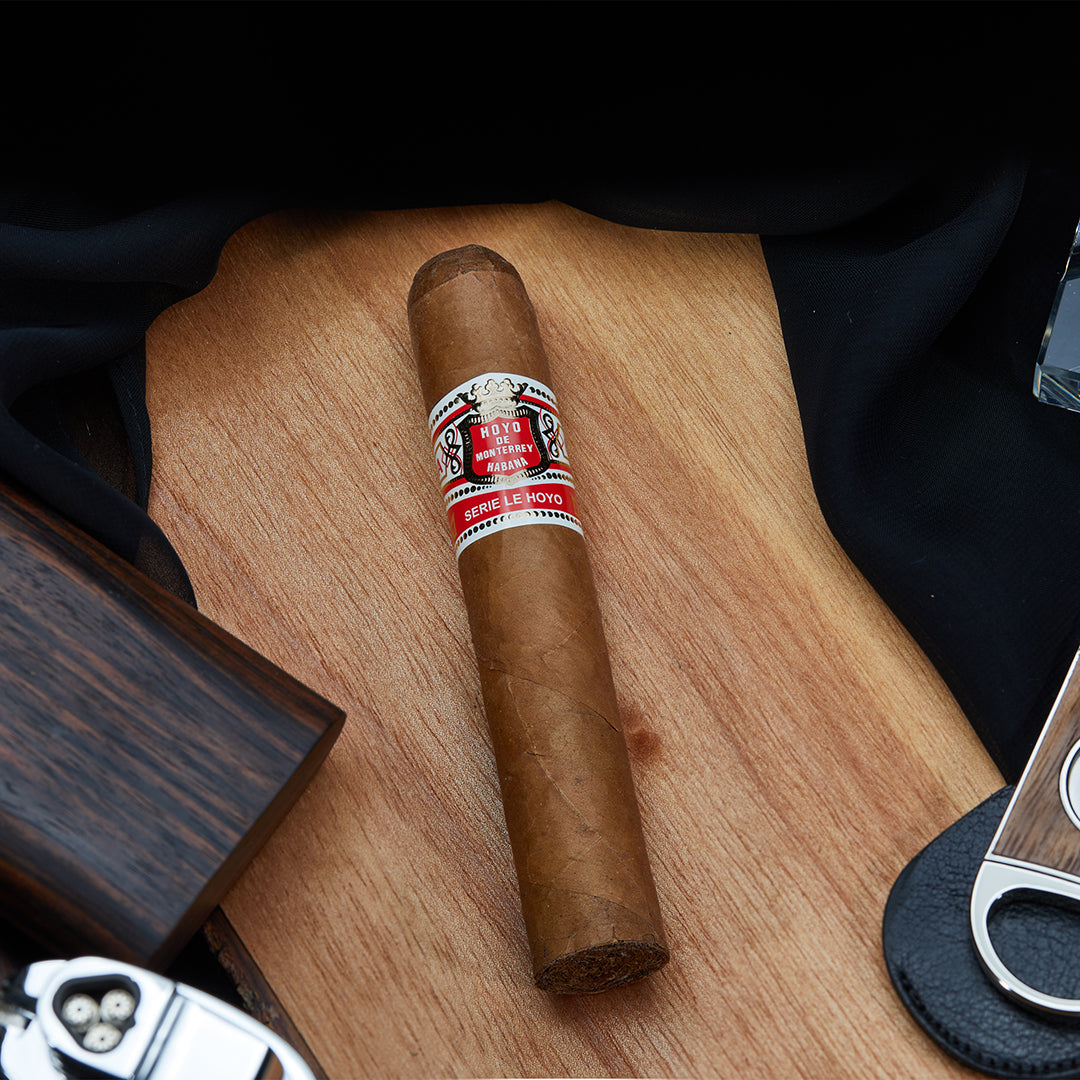 Hoyo de Monterrey Rio Seco Robusto Extra Cuban Cigars laid against a wooden background, highlighting their premium craftsmanship and natural tones.