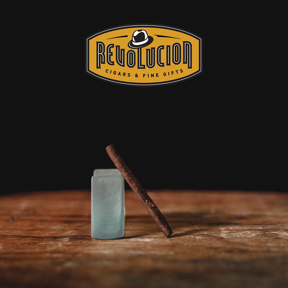 Angled view of a Montecristo Mini Mild-Medium Strength Cuban Cigarillo box, showcasing its elegant design.