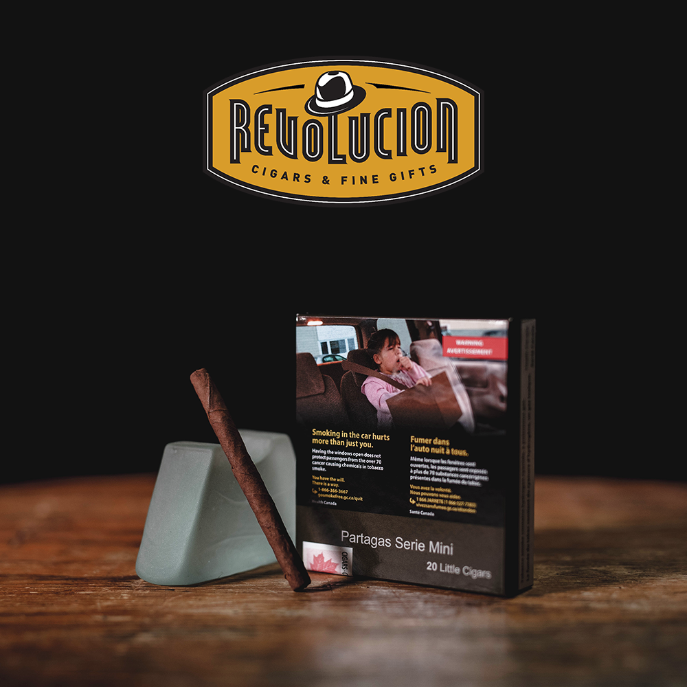 A plain packaging box of Partagás Series Mini Cuban cigarillos, placed next to the original branded box.