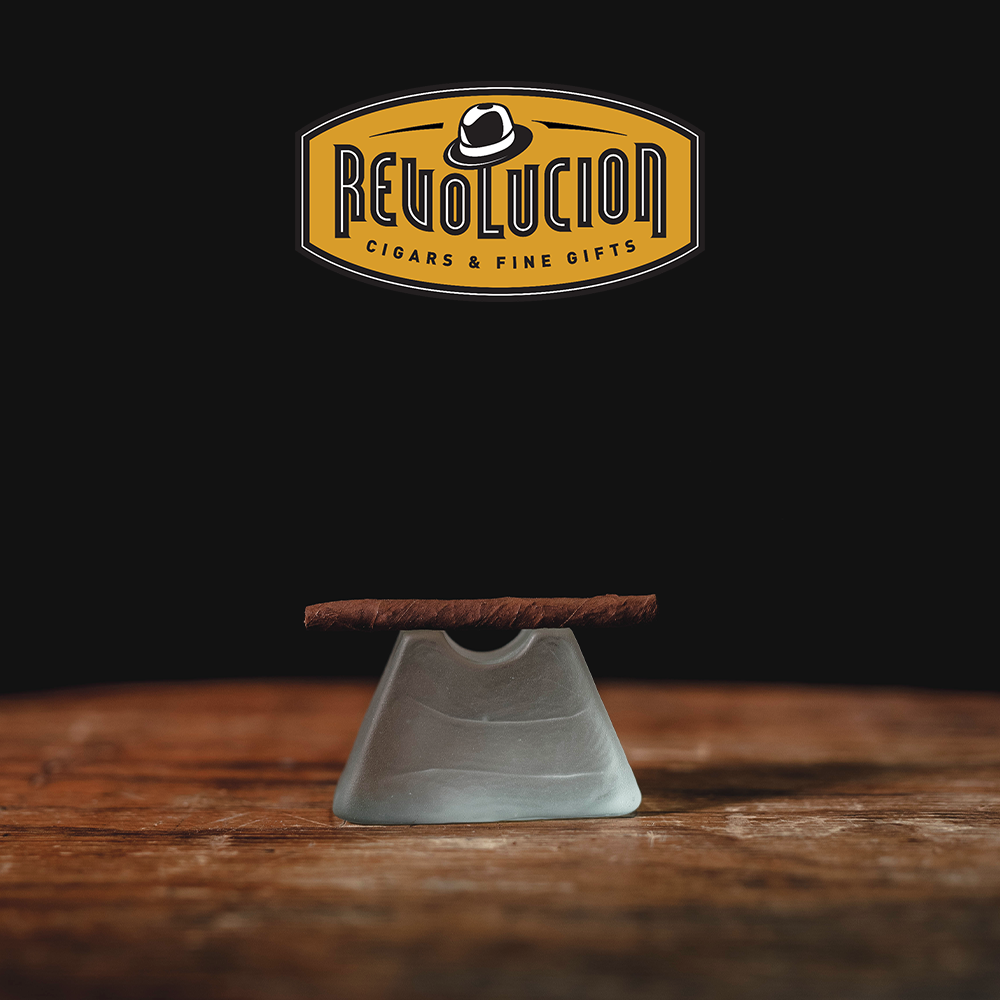 A close-up side view of a Partagás Series Mini Cuban cigarillo, highlighting its texture.