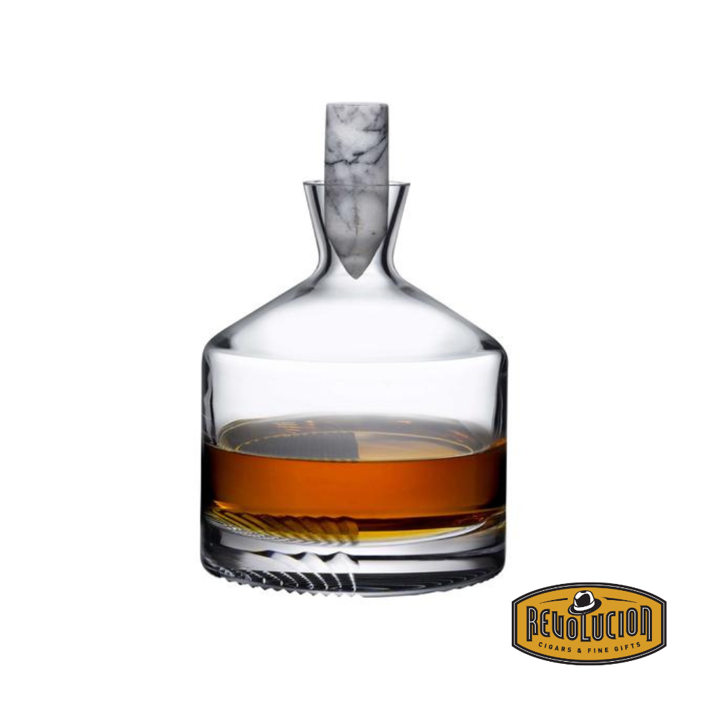 Elegant whiskey carafe with a sleek, modern design, featuring a marble stopper and a partially filled glass base showcasing its refined craftsmanship. Includes the Revolucion Cigars &amp; Fine Gifts logo.