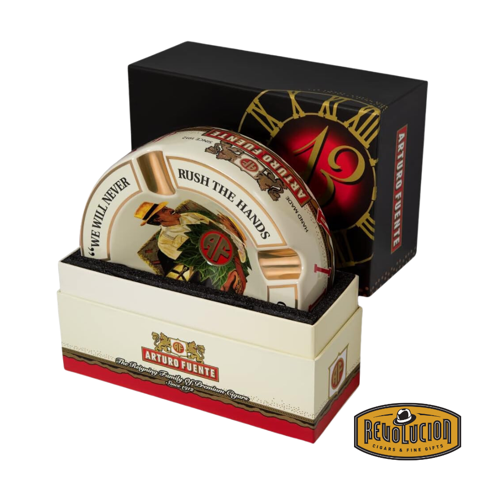 Arturo Fuente &#39;Journey Through Time&#39; Ashtray in Cream, elegantly packaged in a branded box, showcasing the iconic Arturo Fuente artwork and gold cigar grooves, displayed with the Revolucion Cigars &amp; Fine Gifts logo.