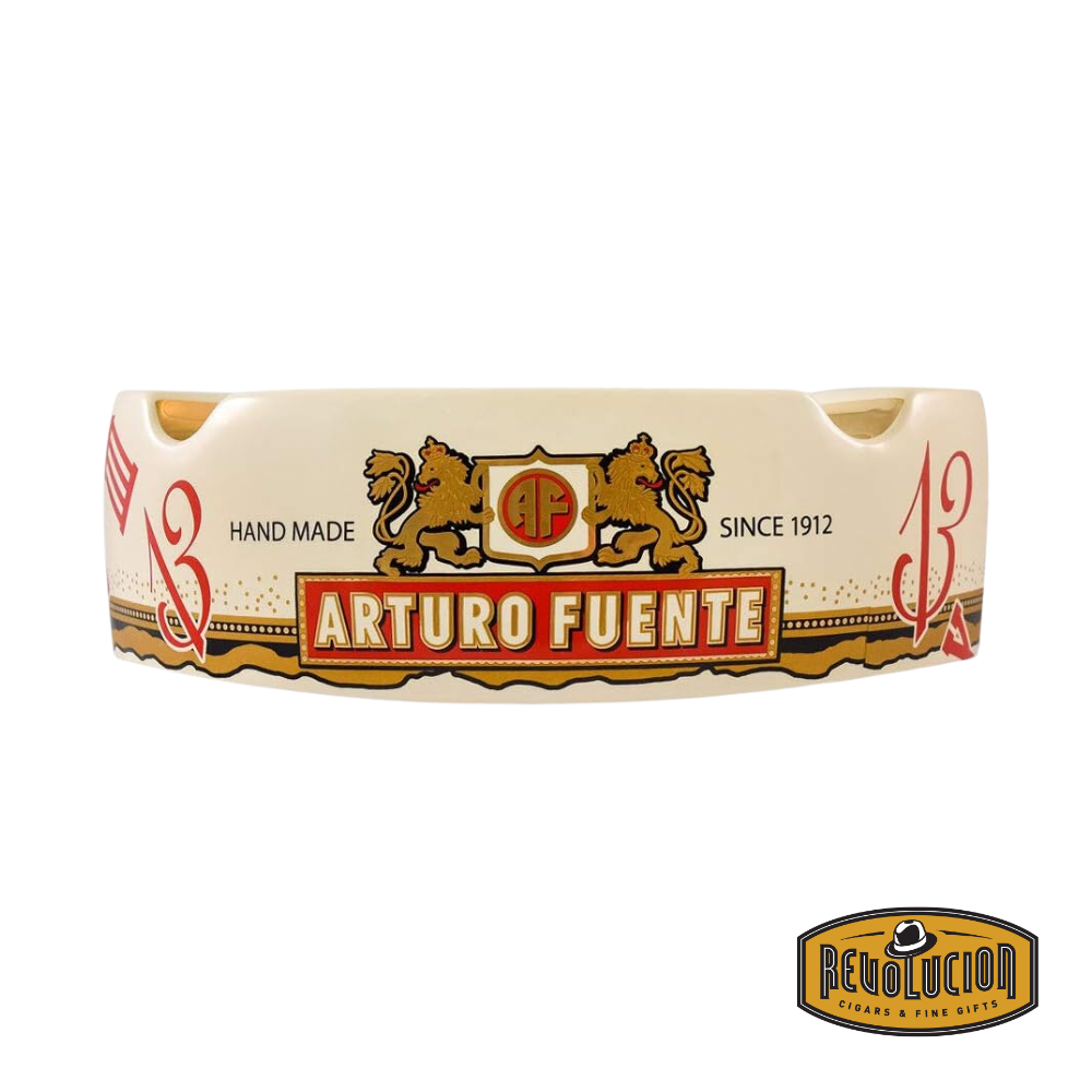 Arturo Fuente 'Journey Through Time' Ashtray in Cream, featuring a vibrant design with four gold cigar grooves and iconic Arturo Fuente artwork, displayed with the Revolucion Cigars & Fine Gifts logo.