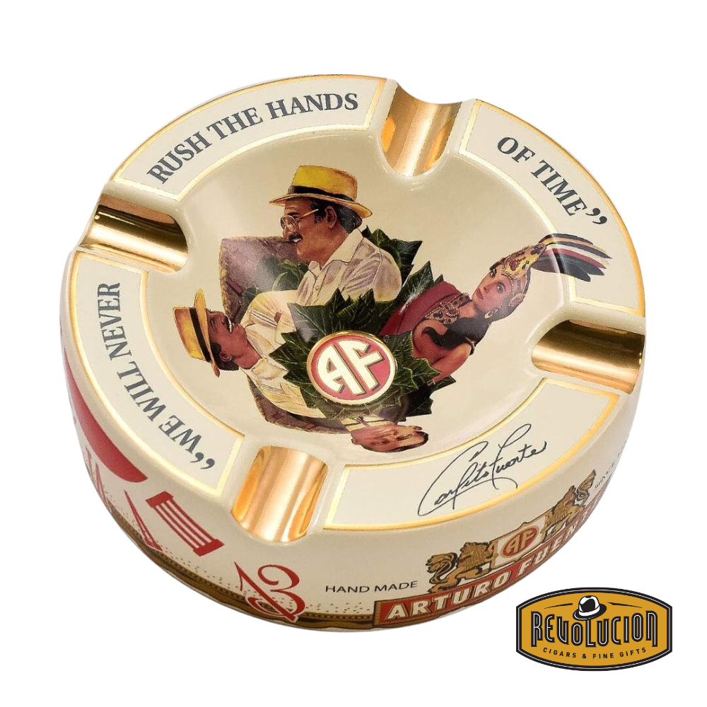 Arturo Fuente 'Journey Through Time' Ashtray in Cream, featuring a vibrant design with four gold cigar grooves and iconic Arturo Fuente artwork, displayed with the Revolucion Cigars & Fine Gifts logo.