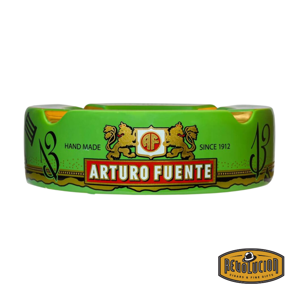 Arturo Fuente 'Journey Through Time' Ashtray in Green, featuring a vibrant design with four gold cigar grooves and iconic Arturo Fuente artwork, displayed with the Revolucion Cigars & Fine Gifts logo.