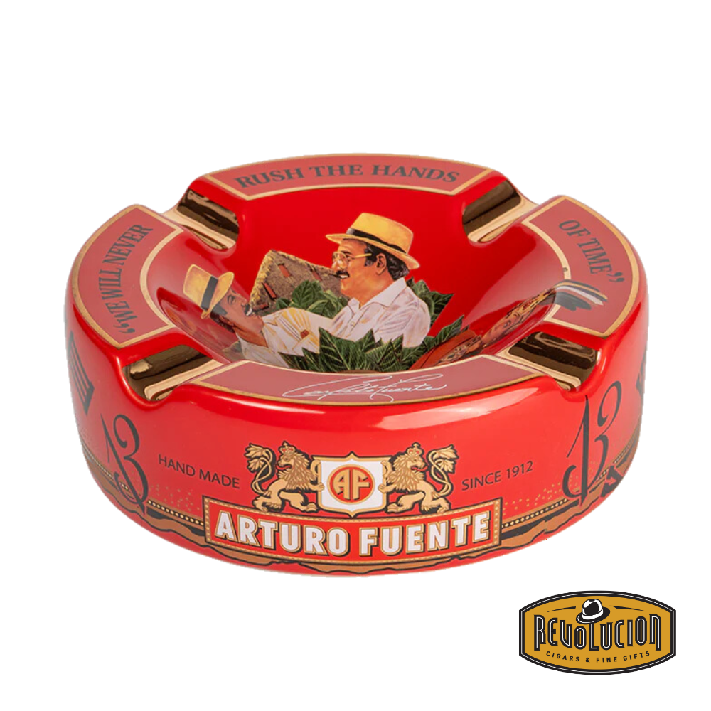 Arturo Fuente 'Journey Through Time' Ashtray in Red, featuring a vibrant design with four gold cigar grooves and iconic Arturo Fuente artwork, displayed with the Revolucion Cigars & Fine Gifts logo.