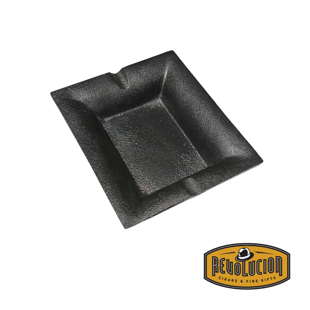 A front-angled view of a cast iron ashtray, showcasing its deep bowl and well-crafted cigar rests.