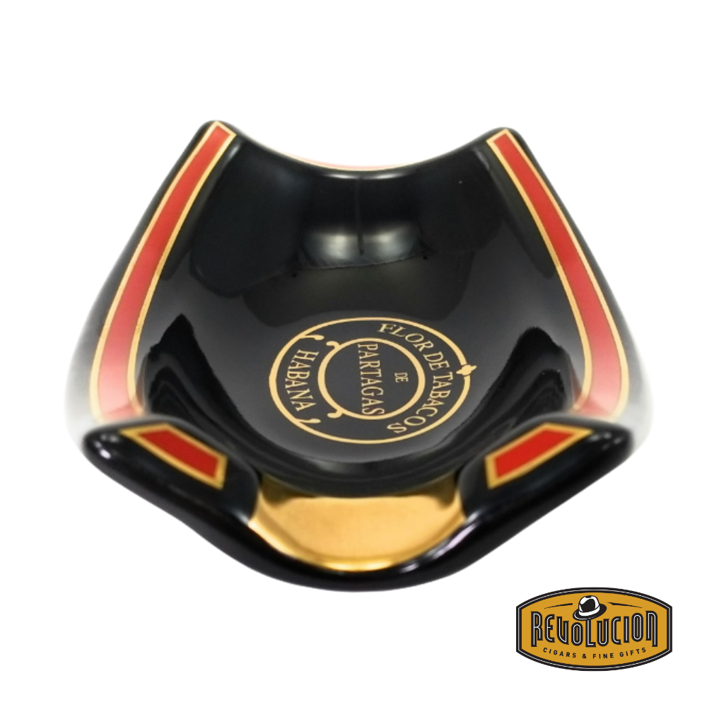 A side view of the Ashtray Habanos Partagas Serie 1 Cigar, featuring a sleek black ceramic body with red and gold trim, and the "Flor de Tabacos de Partagas Habana" emblem at the center.