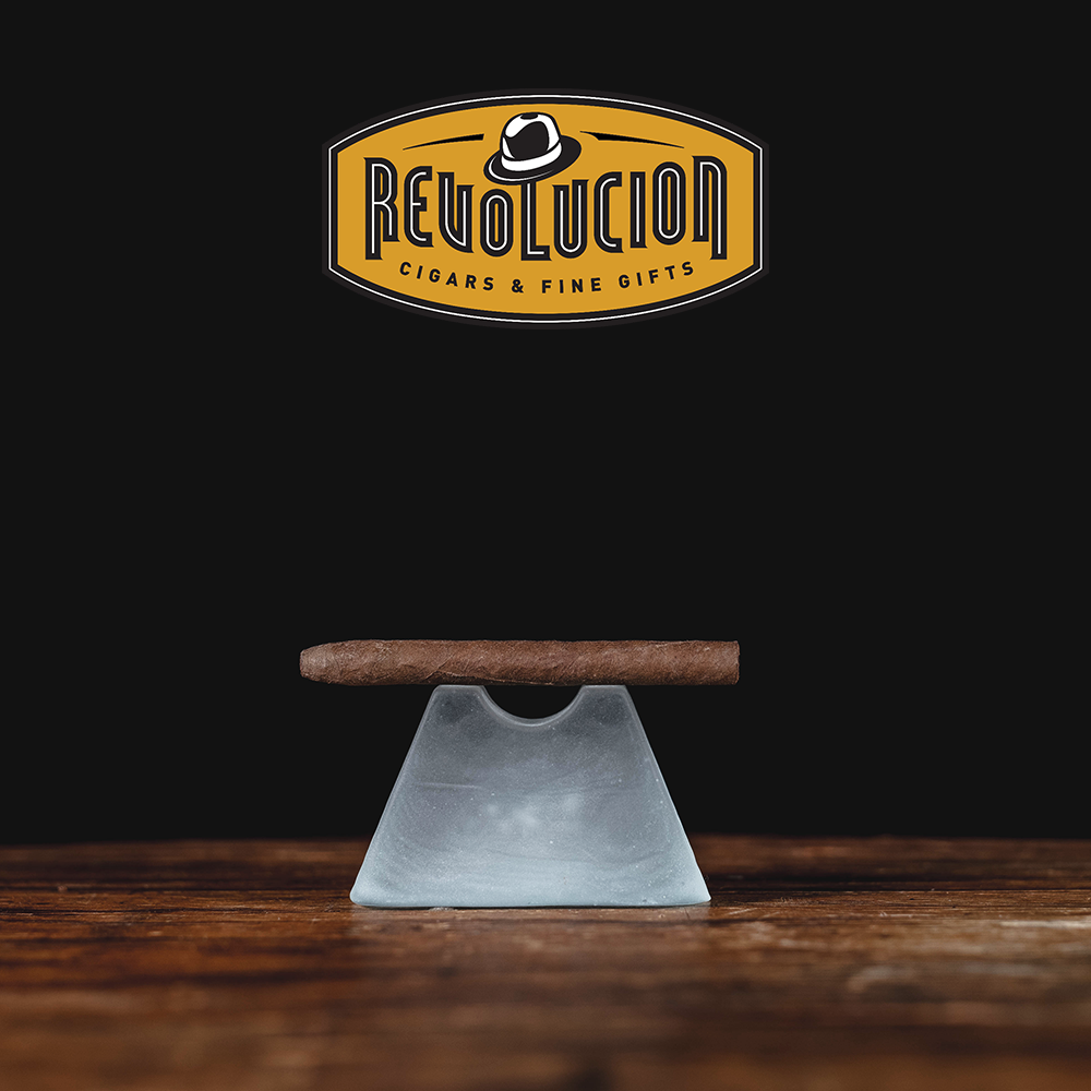An Azan Corto cigarillo positioned at an angle, highlighting its smooth wrapper.