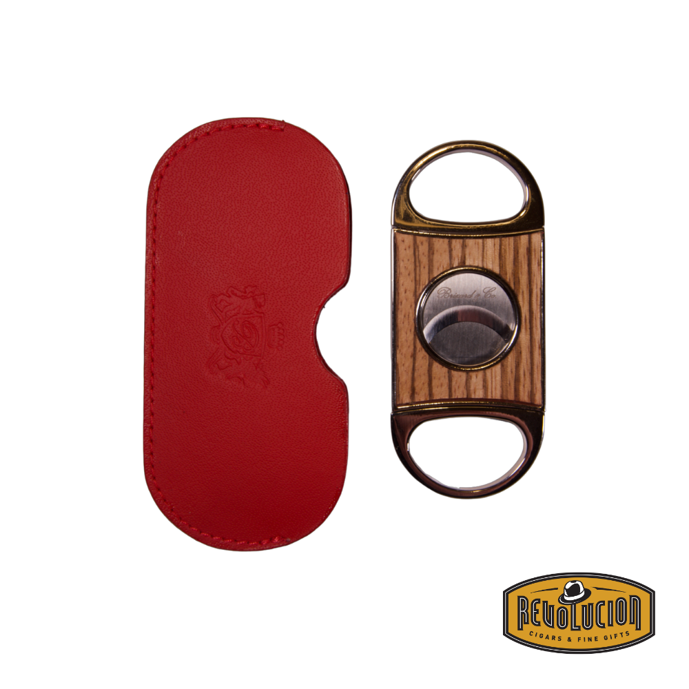 Brizard & Co. Double Guillotine II Cigar Cutter in zebrawood, placed next to its racing red leather case, showcasing a refined and stylish design.