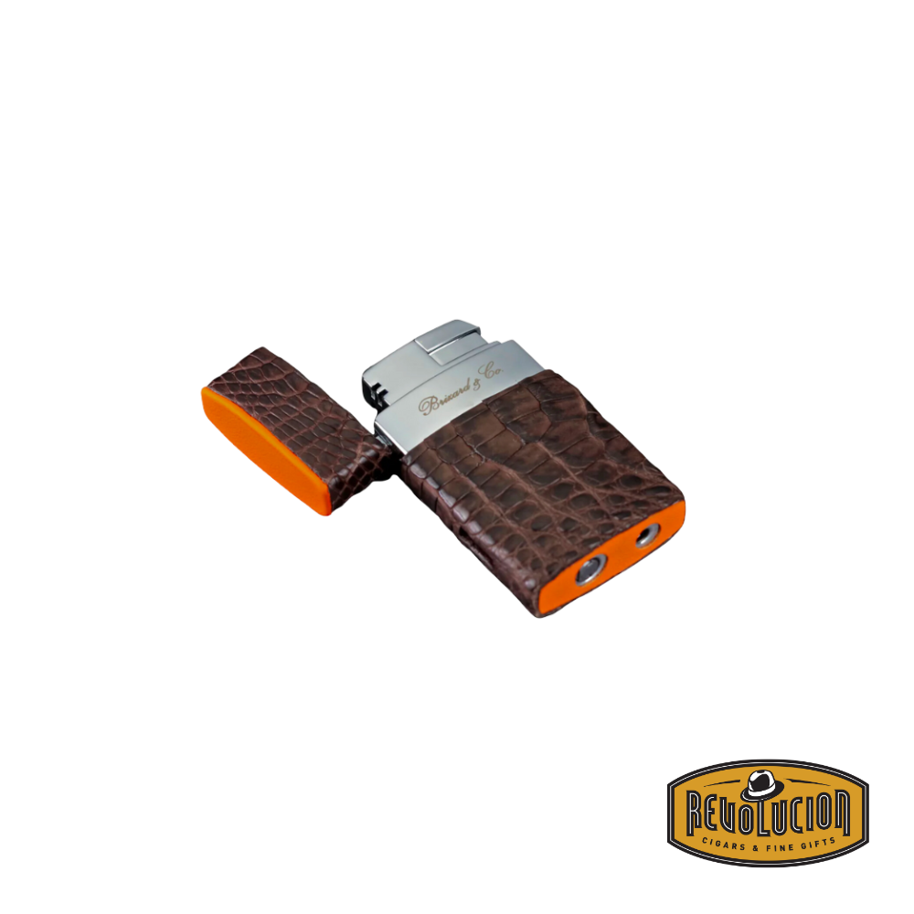 Opened-on-the-floor view of the Brizard &amp; Co Venezia Single Flame Lighter - Genuine Caiman Tobacco &amp; Racing Orange, emphasizing its refined design and precision single flame mechanism.