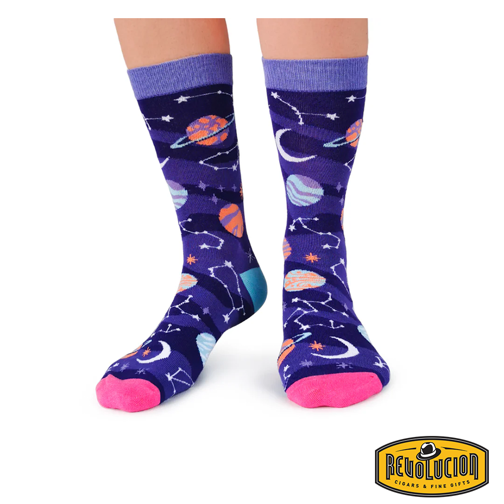 Front view of purple socks adorned with vibrant celestial graphics, including planets, stars, and constellations. The socks feature light purple cuffs, pink toes, and turquoise heels