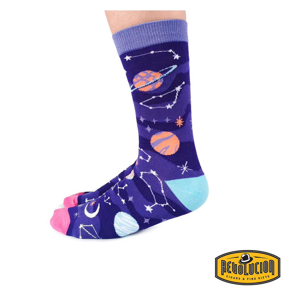 Front view of purple socks adorned with vibrant celestial graphics, including planets, stars, and constellations. The socks feature light purple cuffs, pink toes, and turquoise heels