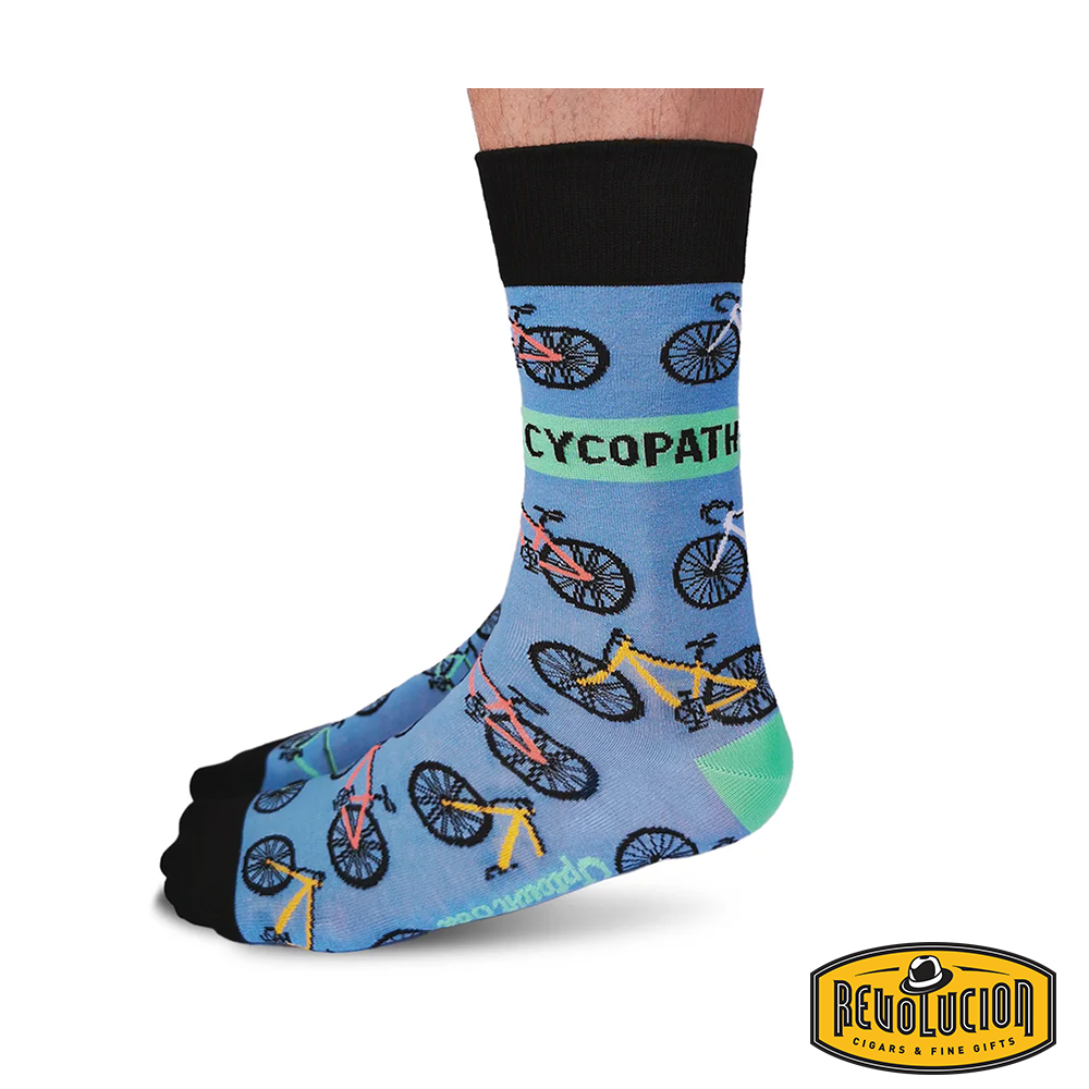 Front view of blue socks with colorful bicycle graphics and black cuffs and toes. The socks are branded with the Revolucion Cigars & Fine Gifts logo.